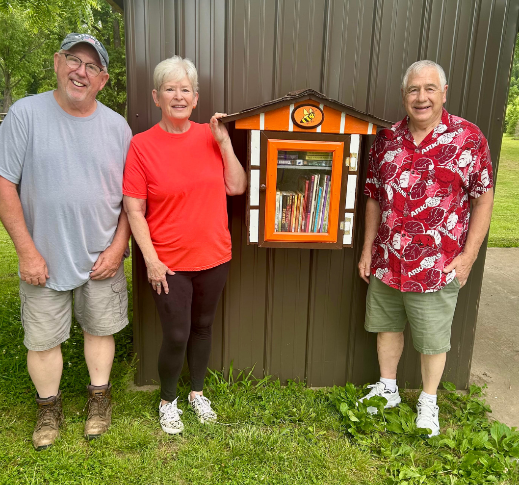 Volunteer team displaying new Little Free Library in the Park